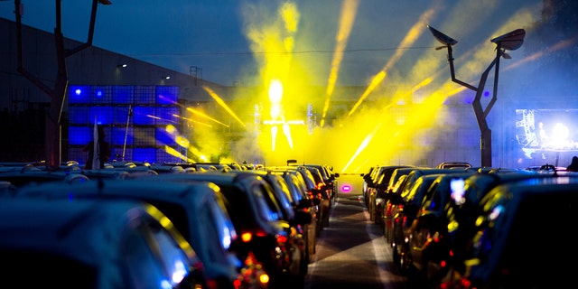 April 30, 2020, Lower Saxony, Schuttorf: Guests park their cars during a car disco in the parking lot of the disco "Index". This large-capacity discotheque in Grafschaft Bentheim is offering a car disco for the second time. In 250 cars a total of 500 guests can participate. Photo: Hauke-Christian Dittrich/dpa (Photo by Hauke-Christian Dittrich/picture alliance via Getty Images)