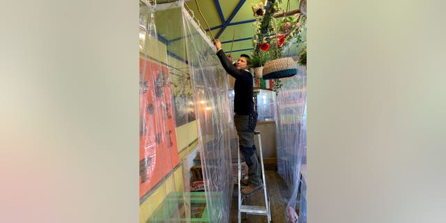 In addition to draping all 16 of his tables in shower curtains, Osorio has purchased air purifying machines for the dining area. In total, he said he's spent around 2,000 pounds, or more than $2,400.