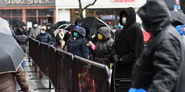 People wait in line for the Food Bank at the New York City mobile food pantry on the Barclays Center plaza on April 24, 2020 in the Brooklyn, New York. (Photo by Angela Weiss / AFP) (Photo by ANGELA WEISS/AFP via Getty Images)