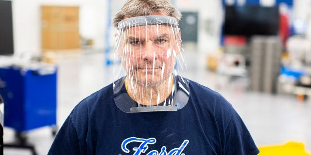 Mar. 24, 2020 – Dave Jacek, 3D printing technical, wears a prototype of a 3D-printed medical face shield printed at Ford’s Advanced Manufacturing Center. Ford Motor Company, joining forces with firms including 3M and GE Healthcare, is lending its manufacturing and engineering expertise to quickly expand production of urgently needed medical equipment and supplies for healthcare workers, first responders and patients fighting coronavirus. (Ford Motor Co. photo)