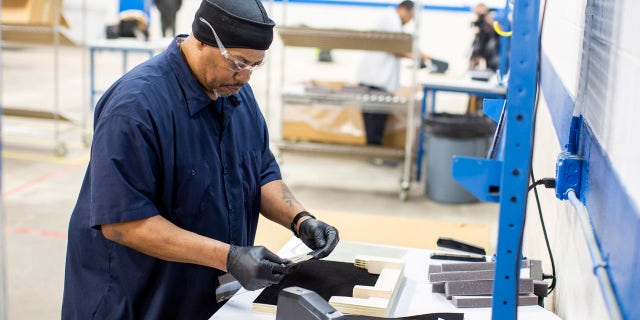 Operators and assemblers assemble medical face shields. Ford Motor Company, in cooperation with the UAW, will assemble more than 100,000 critically needed plastic face shields per week at a Ford manufacturing site to help medical professionals, factory workers and store clerks. (Ford Motor Co. photo)