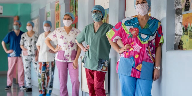 Nurses at Glasgow Royal Infirmary get their hands on a set of wacky scrubs made by volunteers.