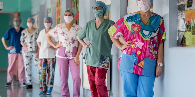 Nurses at Glasgow Royal Infirmary get their hands on a set of wacky scrubs made by volunteers.