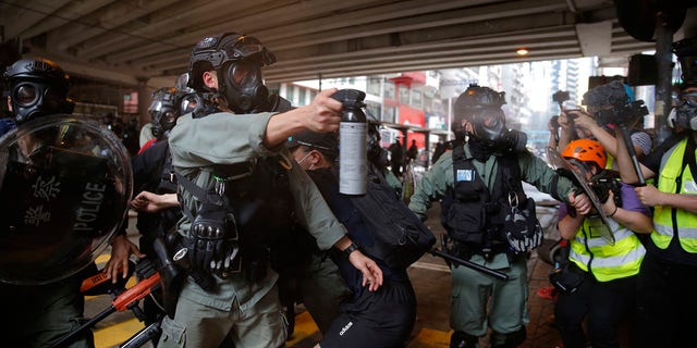 Riot Police use pepper spray on protesters during a protest against Beijing's national security legislation in Causeway Bay in Hong Kong, Sunday, May 24, 2020. (AP Photo/Kin Cheung)