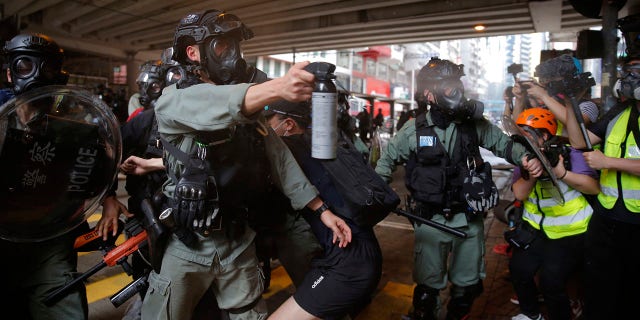 Riot Police use pepper spray on protesters during a protest against Beijing's national security legislation in Causeway Bay in Hong Kong, Sunday, May 24, 2020. (AP Photo/Kin Cheung)