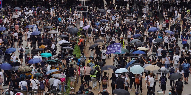 Pro-democracy protesters march during a protest against Beijing's national security legislation in Hong Kong, Sunday, May 24, 2020. (AP Photo/Vincent Yu)