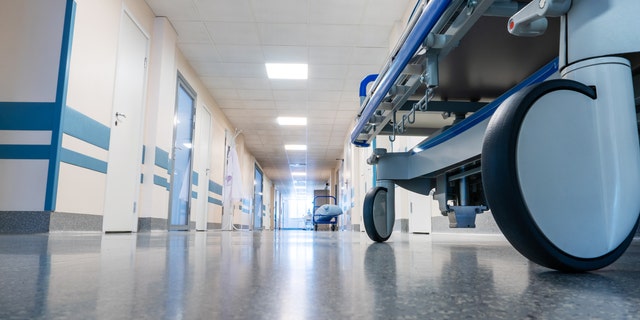 Medical bed on wheels in a hospital corridor. View from below.