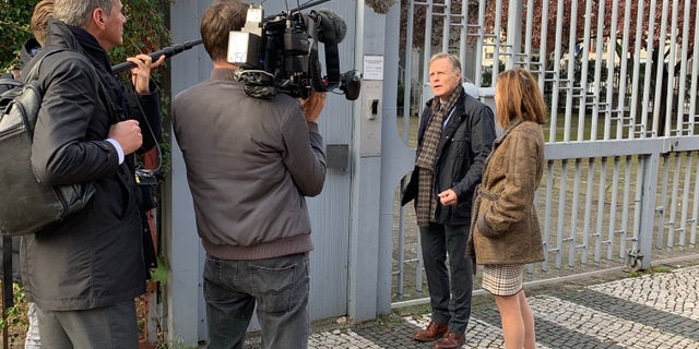 Cindy and Fred Warmbier speak to reporters outside the City Hostel Berlin, which is said to be an illegal money-maker for North Korea.