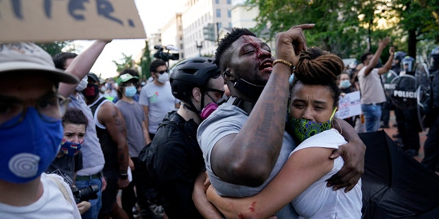 A demonstrator is injured as people protest the death of George Floyd, Saturday, May 30, 2020, near the White House in Washington. Floyd died after being restrained by Minneapolis police officers. (Associated Press)