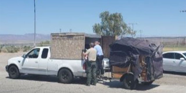 Deputies allegedly found five children in an unventilated crate attached to the back of a pickup truck in Needles, California, Wednesday. Temperatures were nearing 100 degrees. (Courtesy: San Bernardino County Sheriff)