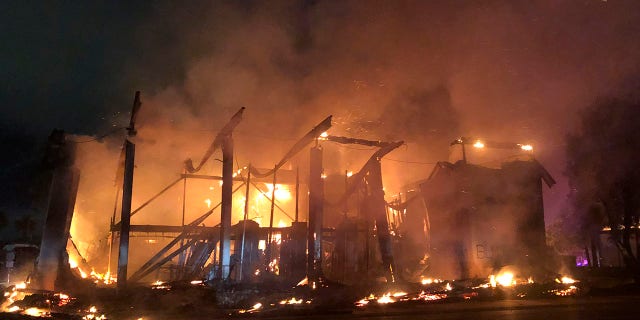 A bank burns during a protest over the death of George Floyd, Sunday, May 31, 2020, in La Mesa, Calif. (AP Photo/Elliot Spagat)