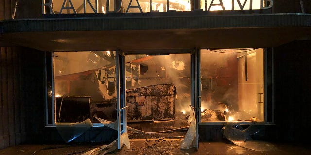 A building on fire in riots over the death of George Floyd on Sunday in La Mesa, Calif. (AP Photo/Elliot Spagat)