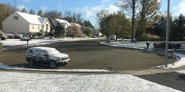 In this photo provided by Robert Beretta, snow accumulates on the grass and vehicles in Monroe, N.Y., Saturday, May 9, 2020.