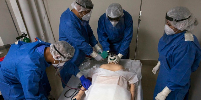 Military doctors and nurses train with a mannequin on the premises of a hospital to receive patients with Covid-19 in Monterrey, Nuevo Leon, Mexico, on May 18, 2020.
