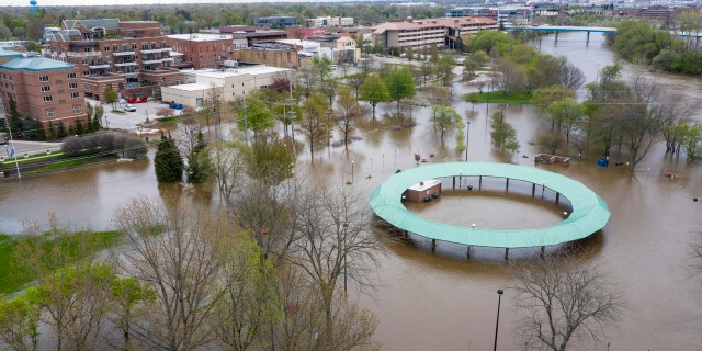 Water floods the Midland Area Farmers Market and the bridge along the Tittabawassee River in Midland, Mich., on May 19.