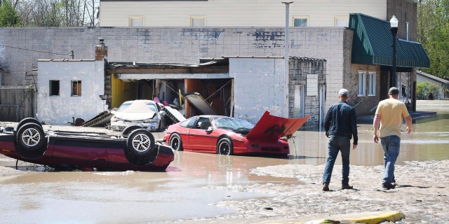 Cars are scattered and tipped over in downtown Sanford, Mich. after flooding along the Tittabawassee River on May 20.