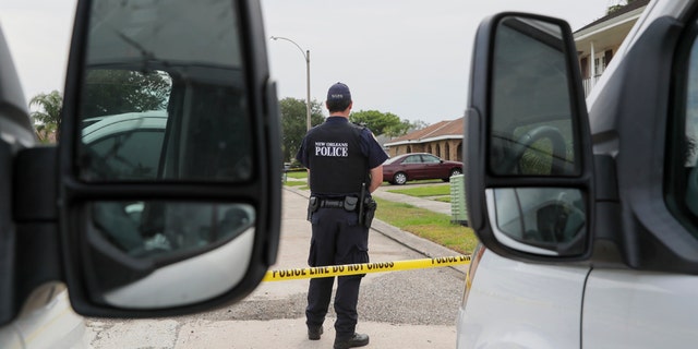 The New Orleans Police Department investigates a double homicide on Arbor Drive in New Orleans East Sunday April 19. (David Grunfeld/The Advocate via AP)