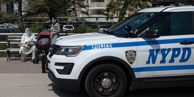 A New York City police car travels on the boardwalk along Brighton Beach with audio announcements blasting, reminding people to keep at least 6 feet apart in the Brooklyn borough of New York, on April 25. With the weather warming up, more people wearing personal protective equipment are seen venturing out to the parks and streets, though most still respecting the social distancing guidelines. (AP Photo/Wong Maye-E)