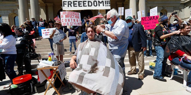 Manke gave free haircuts outside the Capital in Lansing as part of "Operation Haircut" on May 20. (AP Photo/Paul Sancya)