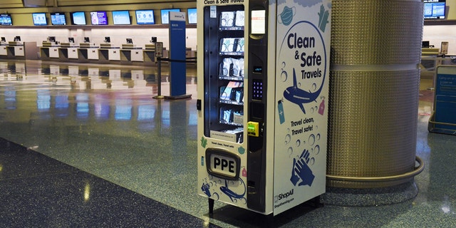 A personal protective equipment vending machine is set up in the Terminal 1 ticketing area. (Ethan Miller/Getty Images)