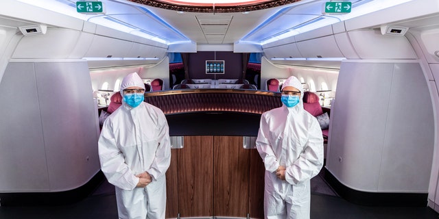 Qatar Airways has announced that cabin crew employees will begin wearing hazmat-style suits, pictured, during flights to enhance onboard safety.
