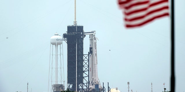 The SpaceX Falcon 9, with the Crew Dragon spacecraft on top of the rocket, sits on Launch Pad 39-A Monday, May 25, 2020, at Kennedy Space Center, Fla. Two astronauts will fly on the SpaceX Demo-2 mission to the International Space Station scheduled for launch on May 27. (AP Photo/David J. Phillip)