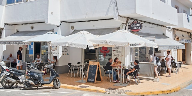 Customers in a coffee shop in Sant Francesc on May 06, 2020 in Formentera, Spain. Among its 12,000 inhabitants (approximately) currently registered, there have been seven people infected with coronavirus, of which only two are still active, and one dead victim. Since May 4th, Formentera residents are allowed to have a bath in the beach and, after 50 days of lockdown, bars and restaurants are open to public with public attendance limitations.