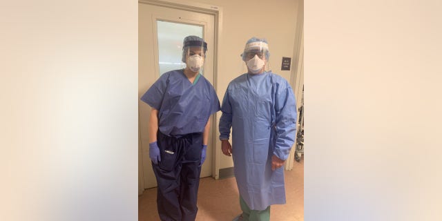 Two AFT union members in personal protective equipment provided by the union.
