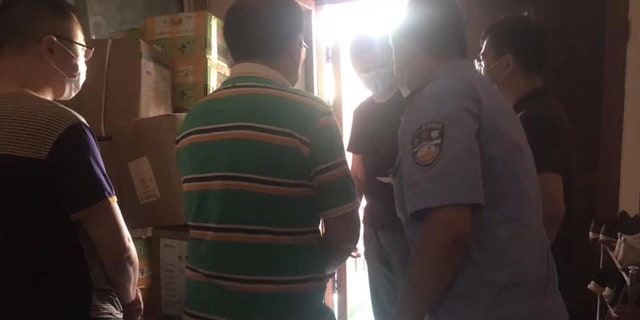 A Chinese pastor identified as Luo is being escorted out of his home after Wuhan police raided his home during an evangelism Zoom event Saturday.