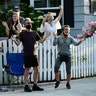 SAG-AFTRA president Gabrielle Carteris, far right, and her husband Charles Isaacs are among the cheering spectators at musician Adam Chester's weekly neighborhood performance in the Sherman Oaks section of Los Angeles, May 9, 2020. 
