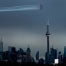 The Canadian Snowbirds circle the CN Tower as part of Operation Inspiration during the COVID-19 pandemic in Toronto, May 10, 2020. 