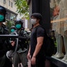 Riot police form a line as they check pedestrians gathered in the Central district of Hong Kong, May 27, 2020. 