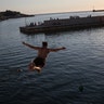 A man dives into the Mediterranean sea from the walls of Fort Saint-Jean as France gradually lifts its COVID-19 lockdown in Marseille, May 26, 2020. 