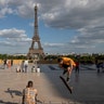 People stroll at Trocadero square near the Eiffel Tower in Paris, May 25, 2020. 