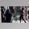 A protestor breaks a window of a business with a baseball bat, Thursday, May 28, 2020, in St. Paul, Minn. Protests over the death of George Floyd, a black man who died in police custody Monday, broke out in Minneapolis for a third straight night.
