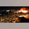 Protestors demonstrate outside of a burning Minneapolis 3rd Police Precinct, Thursday, May 28, 2020, in Minneapolis. 