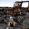 Sandra King, 70, waits for her granddaughter near the remains of AutoZone across from the Minneapolis 3rd Police Precinct in in Minneapolis on Thursday, May 28, 2020. King, who lives in the neighborhood, was brought to a protest by her granddaughter.