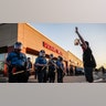 Protestors demonstrate in front of police in riot gear, Thursday, May 28, 2020, in St. Paul, Minn. Protests over the death of George Floyd, a black man who died in police custody Monday, broke out in Minneapolis for a third straight night.