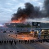 Law enforcement officers amassed along Lake Street near Hiawatha Ave. as fires burned after a night of unrest and protests in the death of George Floyd early Friday, May 29, 2020 in Minneapolis. 