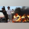 Young men stand atop a burning car in the Target parking lot E. Lake St. during a third night of unrest following the death of George Floyd while in Minneapolis police custody early in the week and seen Thursday, May 28, 2020, in Minneapolis, MN.