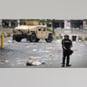 Police and national guard troops stand guard on May 29, 2020. Earlier today, former Minneapolis police officer Derek Chauvin was taken into custody for Floyd's death. Chauvin has been accused of kneeling on Floyd's neck as he pleaded with him about not being able to breathe. Floyd was pronounced dead a short while later. Chauvin and three other officers, who were involved in the arrest, were fired from the police department after a video of the arrest was circulated.