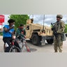 A Minnesota National Guard soldier patrols a street on May 29, 2020. Five hundred National Guard soldiers and airmen have been deployed in Minnesota and St. Paul after three nights of violent protests over the police killing of a black man, the force said Friday. "Our troops are trained to protect life, preserve property and ensure people's right to peacefully demonstrate," said Major General Jon Jensen of the Minnesota National Guard.