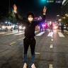 A demonstrator stands at an intersection during a protest Wednesday, May 27, 2020, in Los Angeles over the death of George Floyd in Minneapolis police custody earlier in the week.