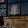 A man uses fencing to strike the Minneapolis police 3rd Precinct building on Wednesday, May 27, 2020, in Minneapolis, protesting against the death of George Floyd in police custody earlier in the week.