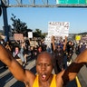 Demonstrators march during a protest of the death of George Floyd, a black man who was in police custody in Minneapolis, in downtown Los Angeles, Wednesday, May 27, 2020.