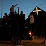 Protests ride down a street in Minneapolis.