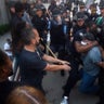 Police officers and protesters clash near CNN Center Friday in Atlanta.