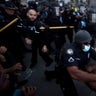 Police officers and protesters clash near CNN Center Friday in Atlanta