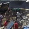 Rescue workers gather at the site after a Pakistan International Airlines flight crashed in a residential neighbourhood in Karachi on May 22, 2020. (Photo by ASIF HASSAN/AFP via Getty Images)