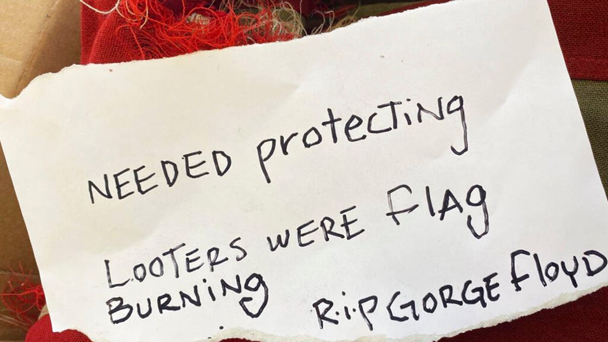 This photo provided by KRNV journalist Kenzie Margiott shows a note addressed to Margiott and a flag from a World War II battleship after it was anonymously returned to KRNV with the note in Reno, Nev., Tuesday, June 2, 2020. (Kenzie Margiott via AP)